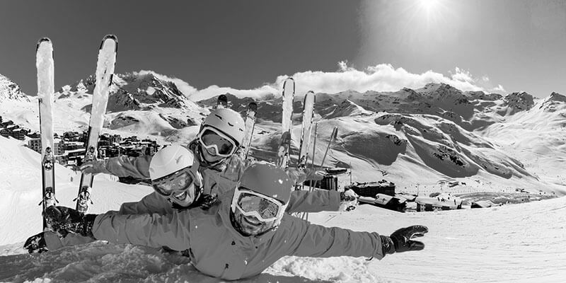 Three skiers having fun in the snow