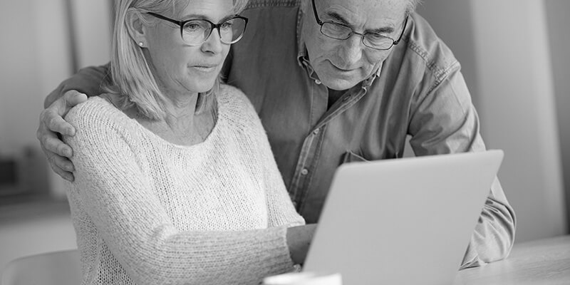 Concerned couple looking at finances on their laptop