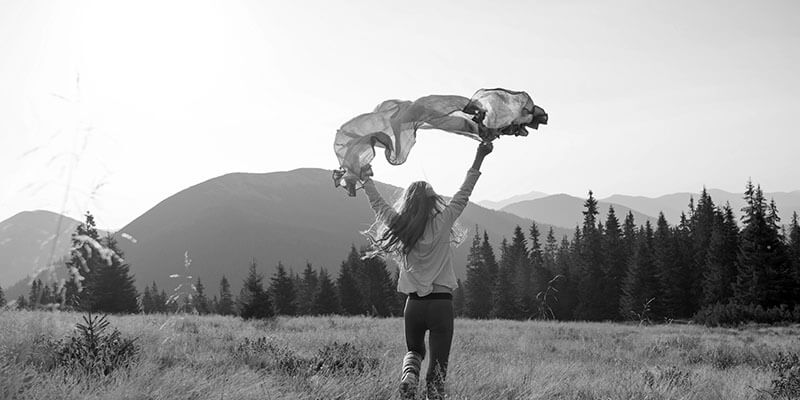 Woman joyously running through a field