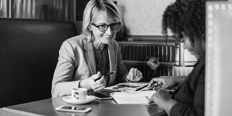 Two woman discussing finances