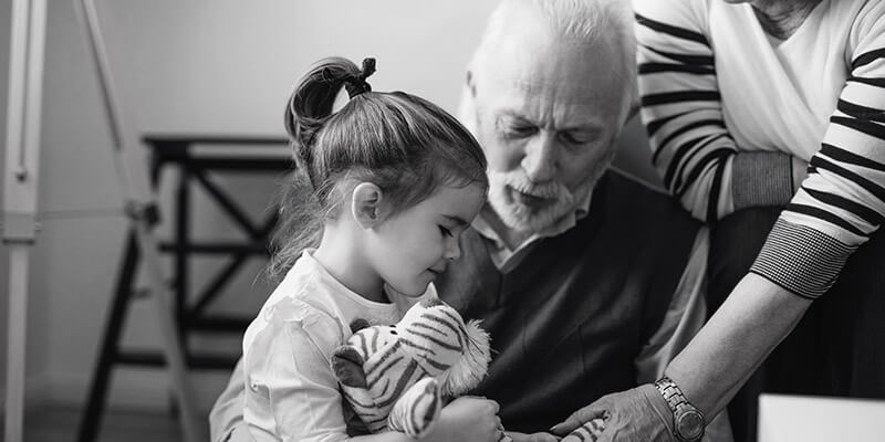 Grandparents playing with granddaughter