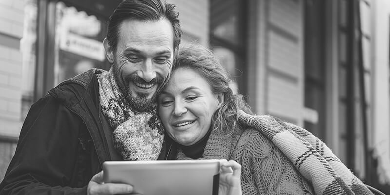 Happy couple looking at a tablet