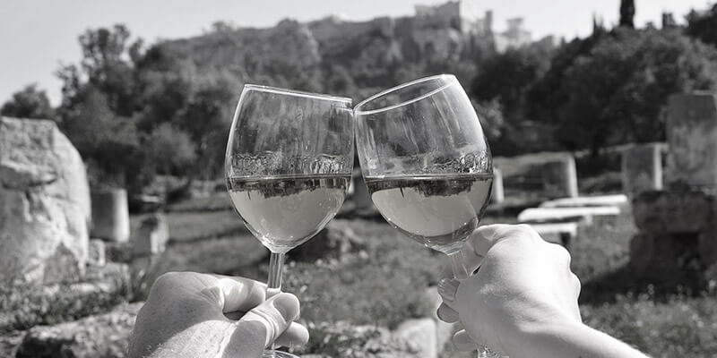 Toasting wine glasses overlooking countryside