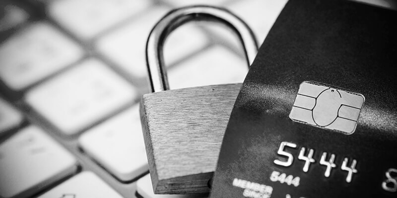 Padlock and bank card on keyboard